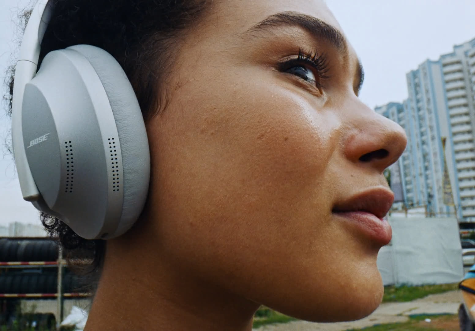 Wide close profile of a woman in headphones